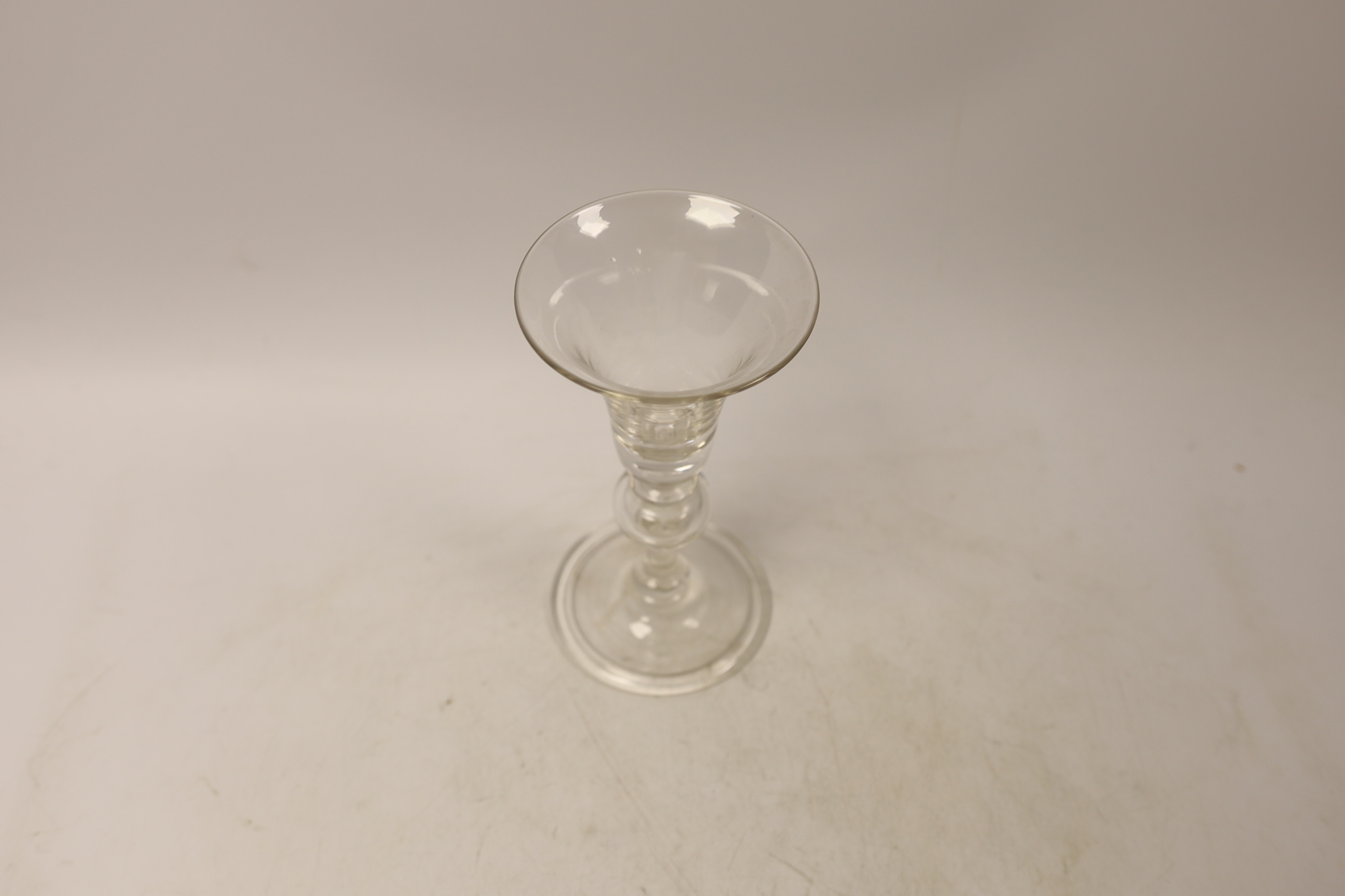 A reproduction wine glass with trumpet shaped bowl, folded foot and single knop, 17cm